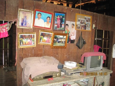 Pictures of family members hanging on the wall.
